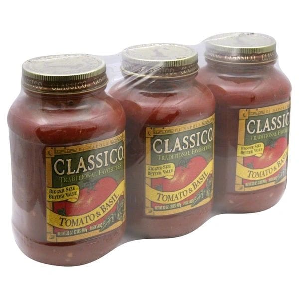 Three jars of tomato sauce are in a plastic bag.