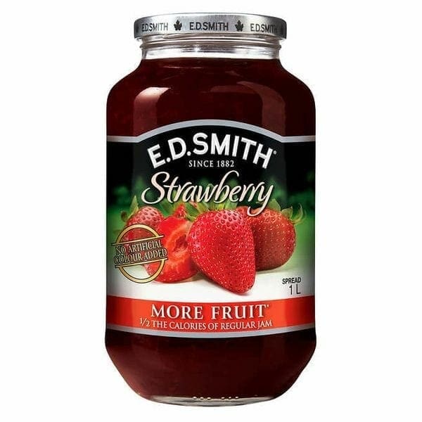 A jar of strawberry jam with strawberries on it.
