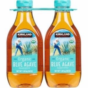 Two bottles of blue agave syrup are hanging from a wire.
