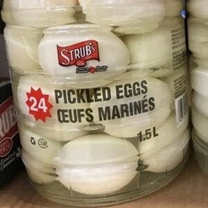 A jar of eggs on the shelf in a store.