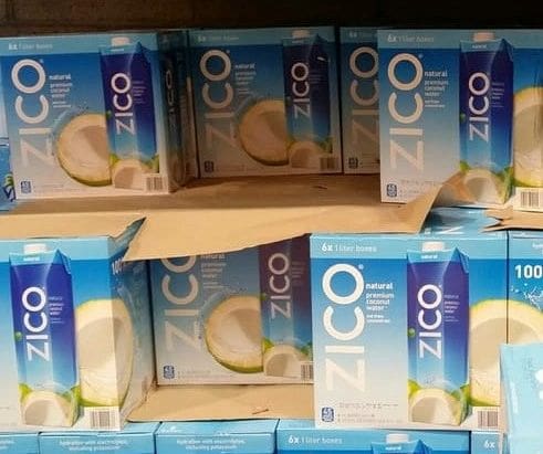 A shelf of boxes of zico juice