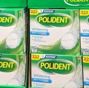 A pile of boxes of polident whitening tooth paste.