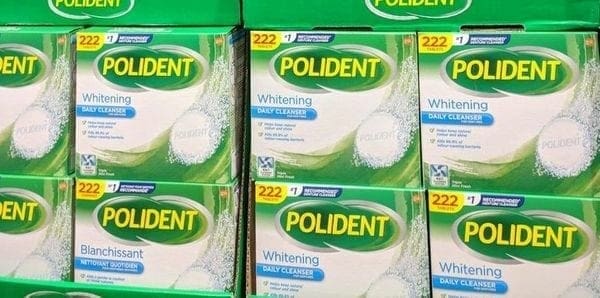 A pile of boxes of polident whitening tooth paste.