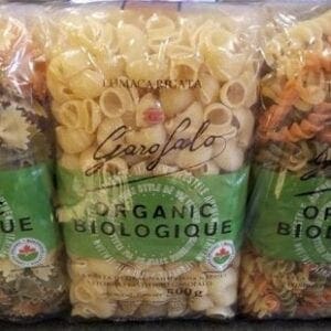 Three bags of pasta sitting on a counter.