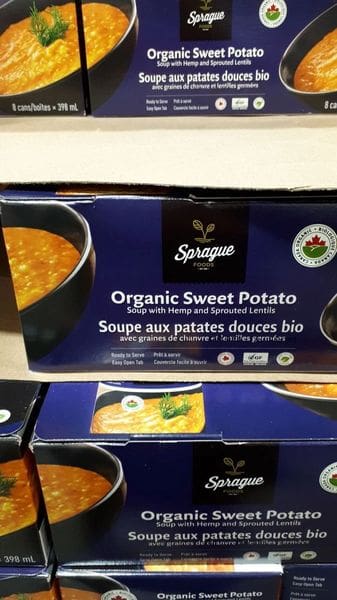 A box of organic sweet potato soup with honey and sprinkled lentils.