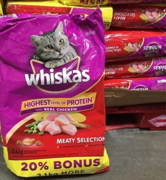 A bag of whiskas cat food sitting next to other bags.