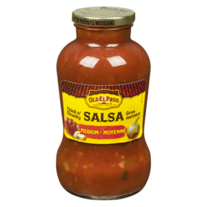 A jar of salsa on top of a green background.