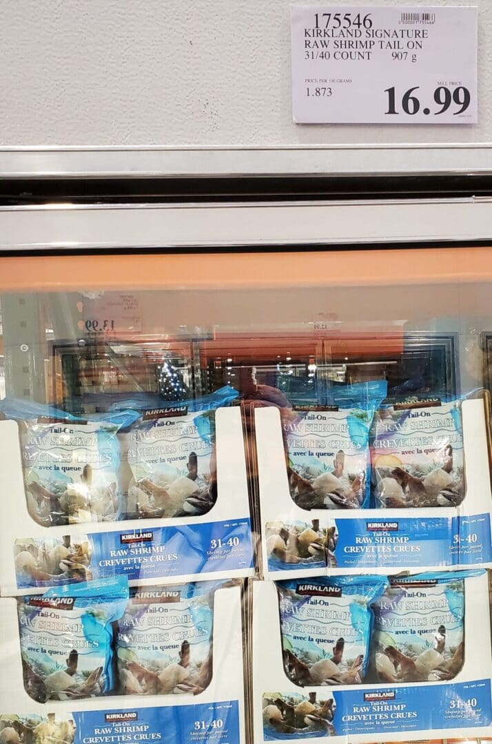 A display case filled with bags of frozen fish.
