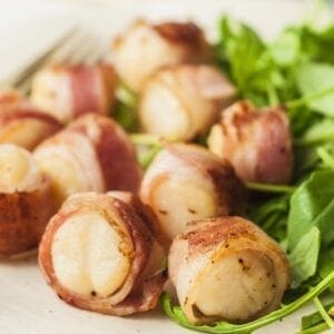 A plate of food with bacon wrapped potatoes.