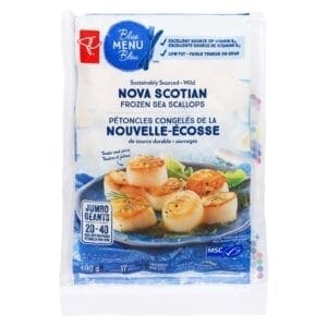 A package of frozen scallops on a plate.
