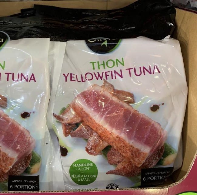 A box of tuna with bacon on it