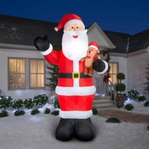 Costco Giant Santa Inflatable with a teddy bear.