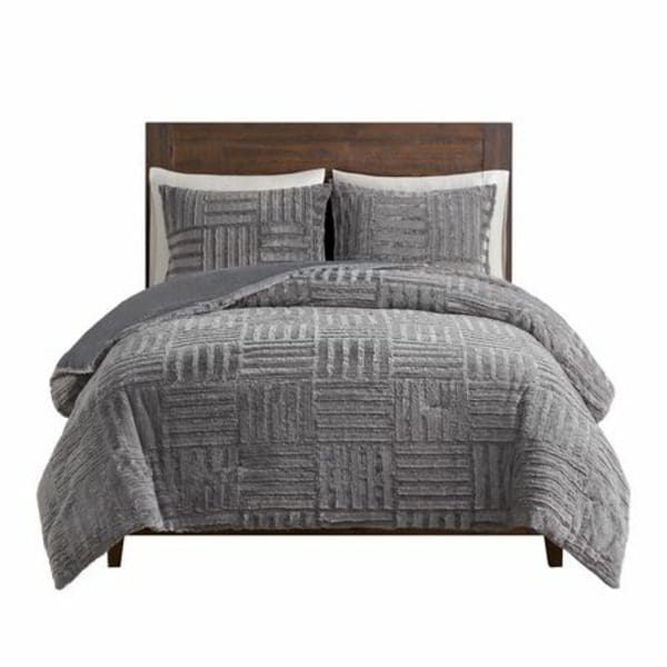 A Canadiana 3 Piece Reversible Comforter Set with a wooden headboard.