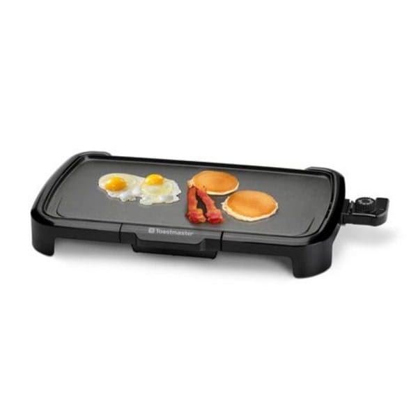 A Toastmaster 10" X 20" griddle with eggs and pancakes on it.