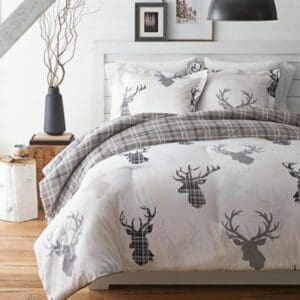 A bedroom with a Canadiana Staghead 3-Piece Comforter Set.