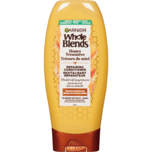 A bottle of Garnier Whole Blends Honey Treasures Conditioner.