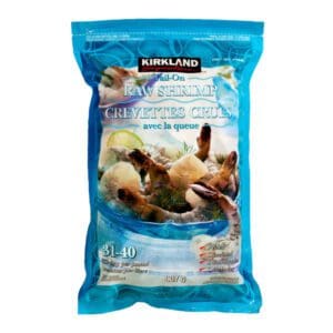 A bag of Kirkland Signature Frozen Tail-On Raw Shrimp on a white background.