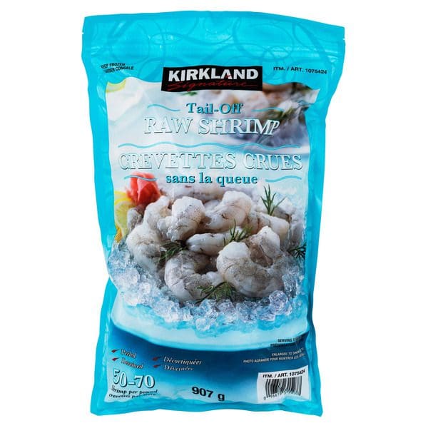 A bag of Kirkland Signature Frozen Tail-Off Shrimp on a white background.